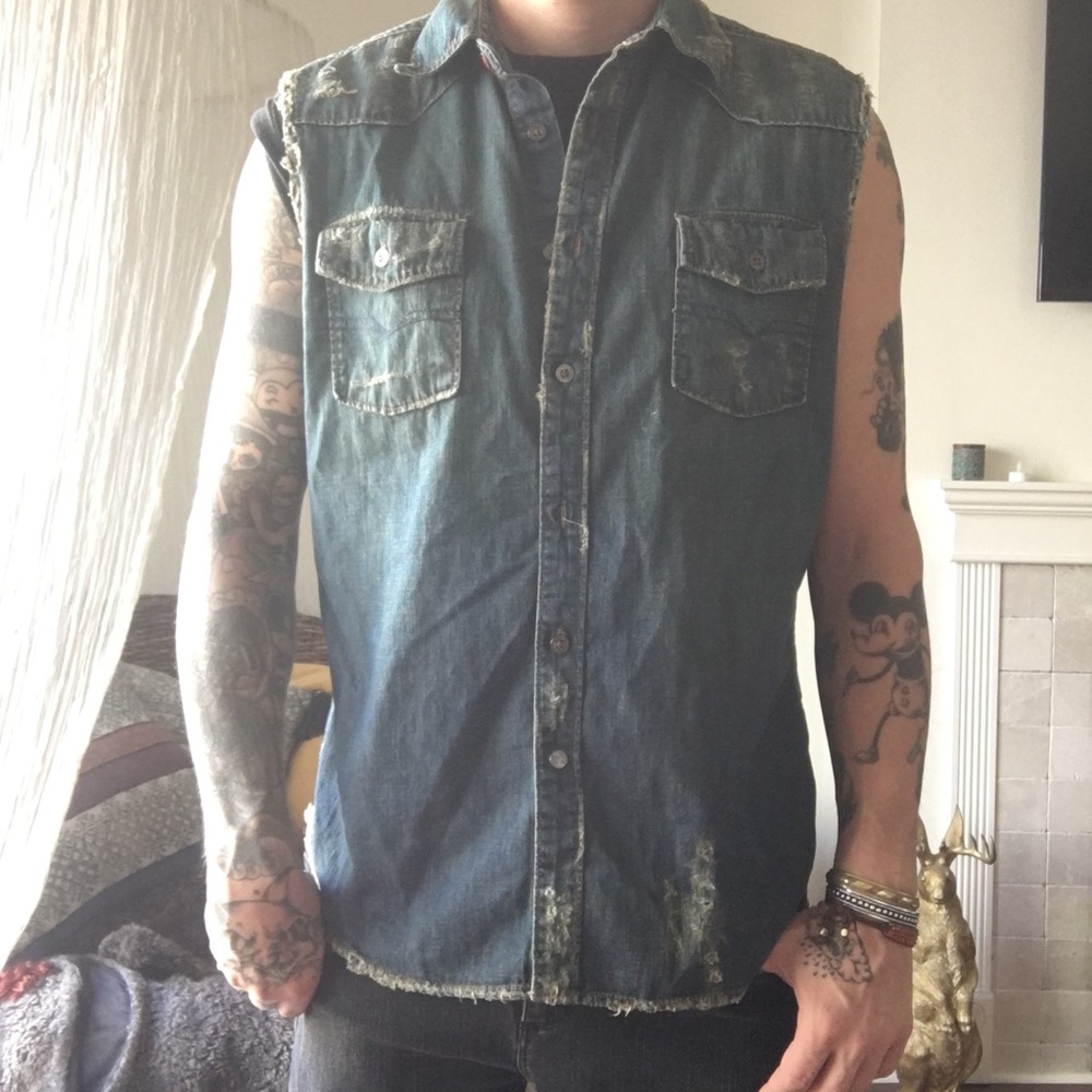 Distressed denim shirt sleeveless.